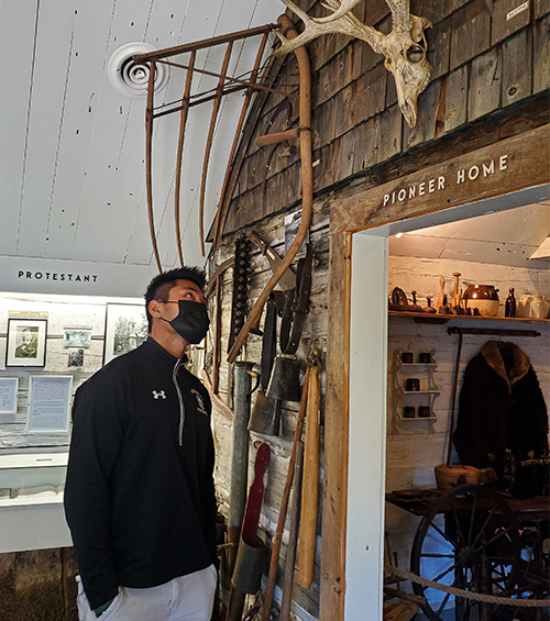 Guest views the Pioneer Room in the historic buildings section of the Madeline Island Museum